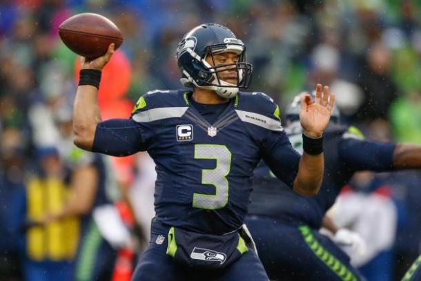 Seattle Seahawks quarterback Russell Wilson throws a pass in an NFL game. Image via Otto Greule Jr./Getty Images