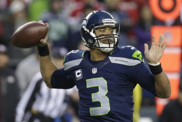 Seattle Seahawks quarterback Russell Wilson throws the ball in an NFL game. Image via Ted S. Warren/AP 