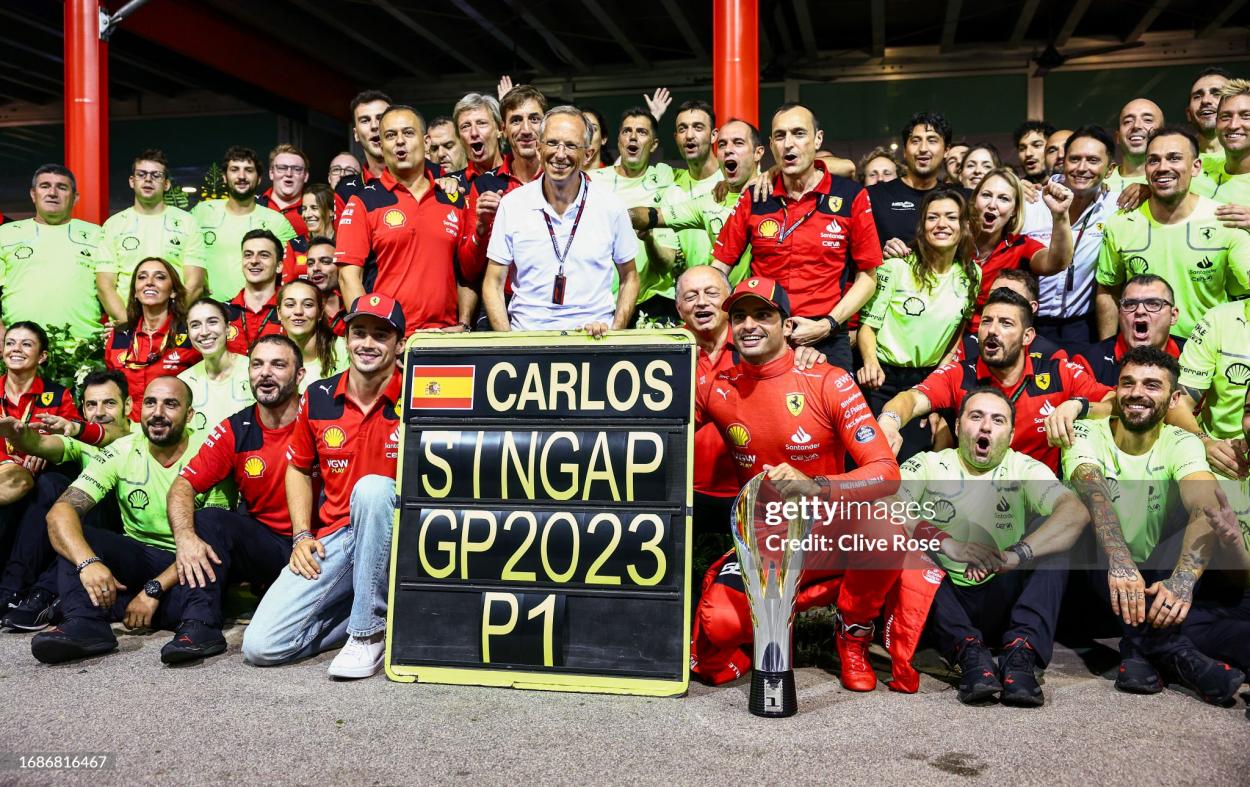 Race winner Carlos Sainz of Spain and Ferrari celebrates with fourth placed Charles Leclerc of Monaco and Ferrari and his team after the F1 Grand Prix of Singapore at Marina Bay Street Circuit on September 17, 2023 in Singapore, Singapore. (Photo by Clive Rose/Getty Images)