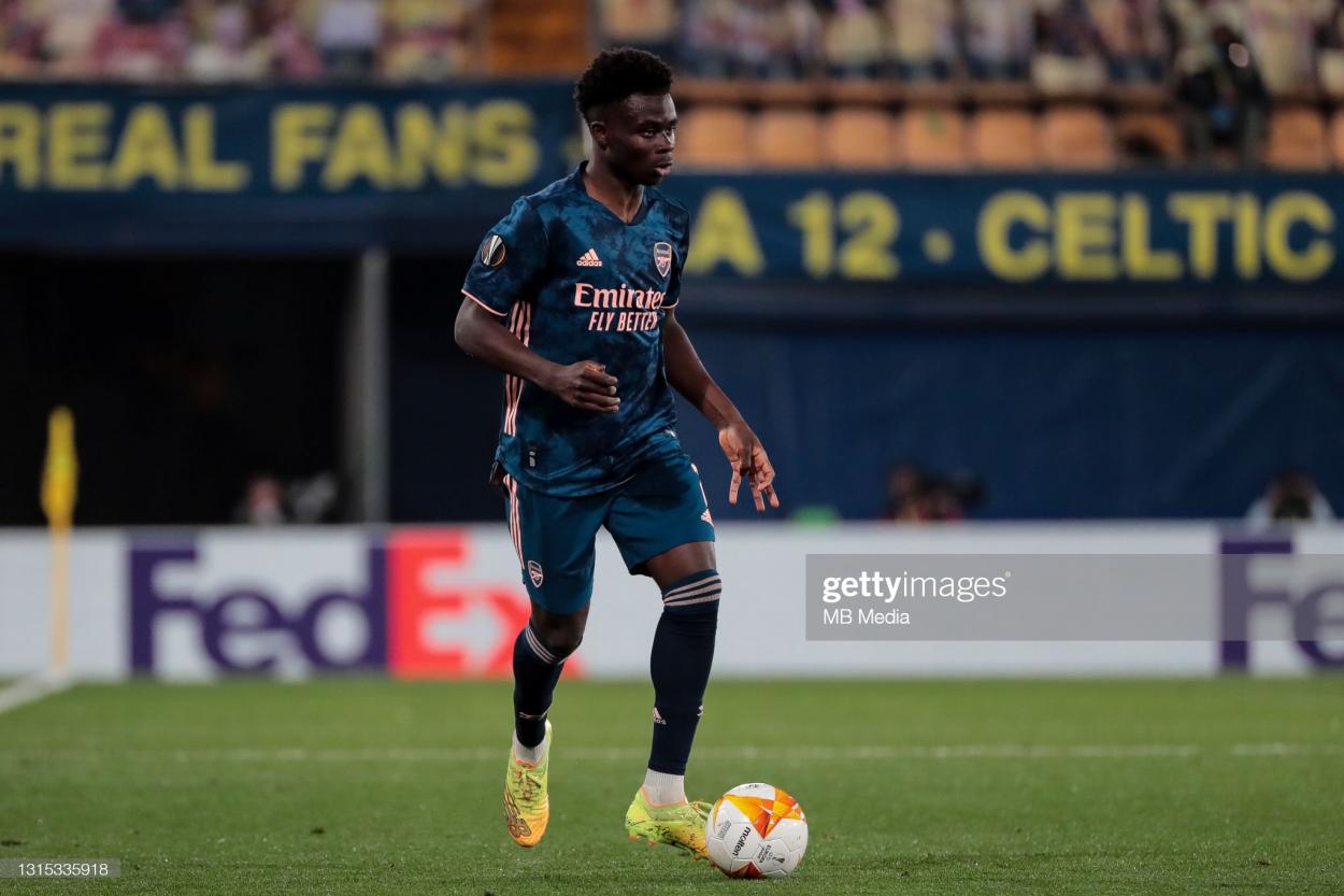 VILLARREAL, SPAIN - APRIL 29: <strong><a  data-cke-saved-href='https://www.vavel.com/en/football/2022/05/05/arsenal/1110628-mikel-arteta-signs-contract-extension-until-2025.html' href='https://www.vavel.com/en/football/2022/05/05/arsenal/1110628-mikel-arteta-signs-contract-extension-until-2025.html'>Bukayo Saka</a></strong> of <strong><a  data-cke-saved-href='https://www.vavel.com/en/football/2022/06/18/arsenal/1114890-eddie-nketiah-signs-new-contract-at-arsenal.html' href='https://www.vavel.com/en/football/2022/06/18/arsenal/1114890-eddie-nketiah-signs-new-contract-at-arsenal.html'>Arsenal FC</a></strong> during the UEFA <strong><a  data-cke-saved-href='https://www.vavel.com/en/football/2022/05/01/arsenal/1110329-the-warm-down-west-ham-united-1-2-arsenal.html' href='https://www.vavel.com/en/football/2022/05/01/arsenal/1110329-the-warm-down-west-ham-united-1-2-arsenal.html'>Europa League</a></strong> Semi-final First Leg match between <strong><a  data-cke-saved-href='https://www.vavel.com/en/football/2021/04/28/arsenal/1069201-villarreal-cf-v-arsenal-preview-team-news-ones-to-watch-predicted-lineups-and-how-to-watch.html' href='https://www.vavel.com/en/football/2021/04/28/arsenal/1069201-villarreal-cf-v-arsenal-preview-team-news-ones-to-watch-predicted-lineups-and-how-to-watch.html'>Villareal CF</a></strong> and Arsenal at Estadio de la Ceramica on April 29, 2021 in Villarreal, Spain. Sporting stadiums around Europe remain under strict restrictions due to the <strong><a  data-cke-saved-href='https://www.vavel.com/en/football/2022/04/01/leicester-city/1107040-manchester-united-vs-leicester-city-match-preview-how-to-watch-team-news-predicted-line-ups-and-ones-to-watch.html' href='https://www.vavel.com/en/football/2022/04/01/leicester-city/1107040-manchester-united-vs-leicester-city-match-preview-how-to-watch-team-news-predicted-line-ups-and-ones-to-watch.html'>Coronavirus Pandemic</a></strong> as Government social distancing laws prohibit fans inside venues resulting in games being played behind closed doors. (Photo by MB Media/Getty Images)