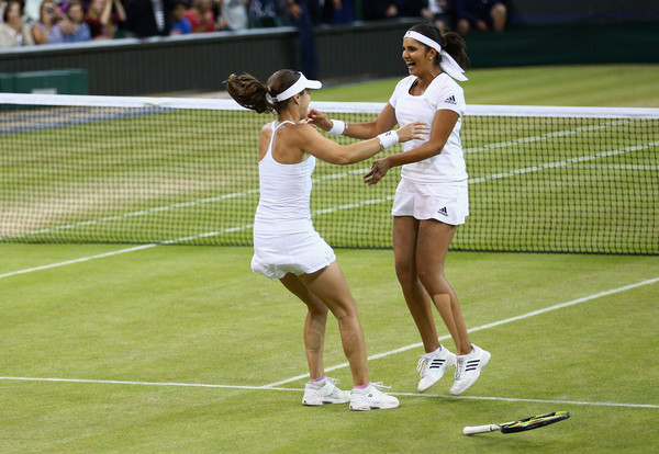 Mirza (right) and Hingis celebrate their Wimbledon win last July. Photo: Clive Brunskill/Getty Images