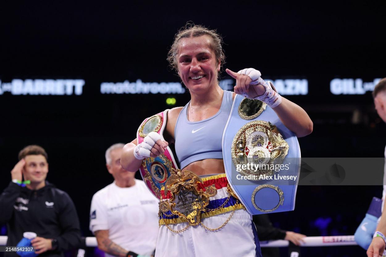 MANCHESTER, ENGLAND - APRIL 13: Ellie Scotney poses for a photo with the title belts after victory over Segolene Lefebvre (not pictured) in the IBF, WBO and Ring Magazine World Super-Bantamweight title fight between Ellie Scotney and Segolene Lefebvre at AO Arena on April 13, 2024 in Manchester, England. (Photo by Alex Livesey/Getty Images)