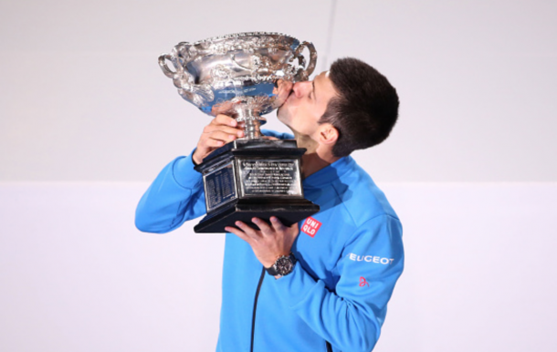 Novak Djokovic of Serbia holds the Norman Brookes Challenge Cup after winning his men's final match as Andy Murray of Great Britain looks on during day 14 of the 2015 Australian Open at Melbourne Park on February 1, 2015 in Melbourne, Australia. (Photo by Michael Dodge/Getty Images)