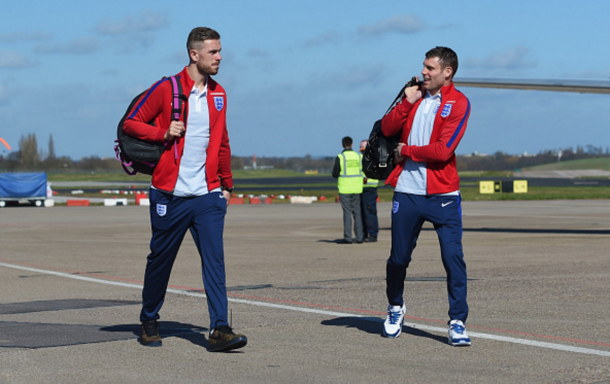 Milner jokes with clubmate Henderson before flying to Berlin earlier in the week. (Picture: Getty Images)