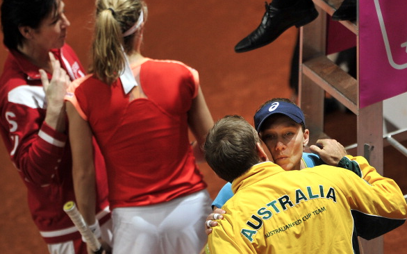 Stosur and Taylor embrace at the 2012 Fed Cup Event.  Photo Courtesy: AFP | Fabrice Coffrini