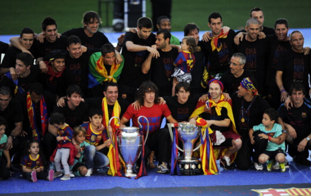 FC Barcelona players pose with the La Liga Tropy and the UEFA Champions League trophy during the celebrations after winning the UEFA Champions League Final against Manchester United at Camp Nou Stadium on May 29, 2011 in Barcelona, Spain. (Photo by David Ramos/Getty Images)