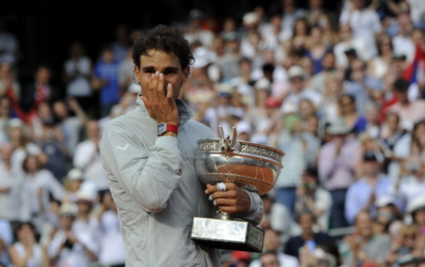 Spain's Rafael Nadal wipes a tear as he holds the Musketeers trophy after winning the French tennis Open men's final match against Serbia's Novak Djokovic at the Roland Garros stadium in Paris on June 8, 2014. AFP PHOTO / DOMINIQUE FAGET (Photo credit should read DOMINIQUE FAGET/AFP/Getty Images)