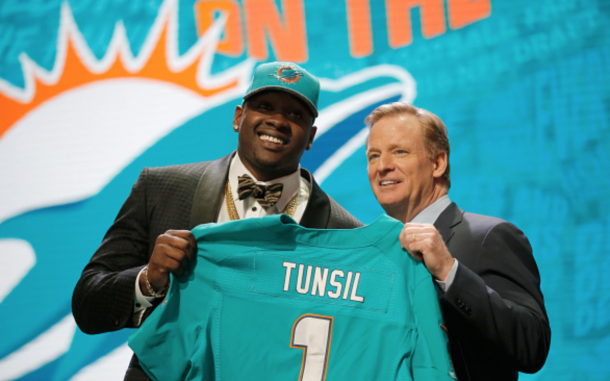 Laremy Tunsil of Ole Miss holds up a jersey with NFL Commissioner Roger Goodell after being picked #13 overall by the Miami Dolphins during the first round of the 2016 NFL Draft at the Auditorium Theatre of Roosevelt University on April 28, 2016 in Chicago, Illinois. (Photo by Jon Durr/Getty Images)