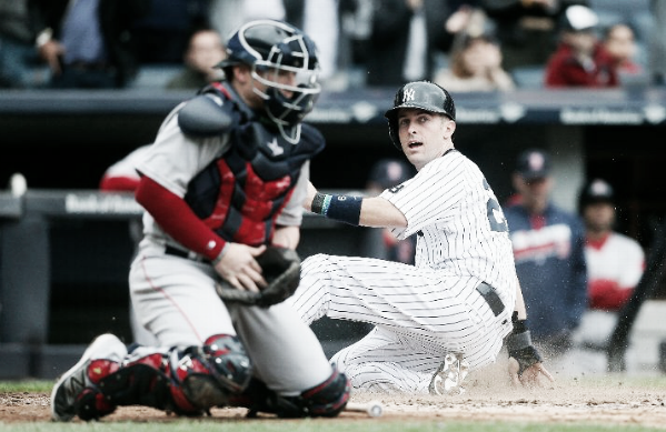 New York's Dustin Ackley slides home in Saturday's 8-2 win. | AP