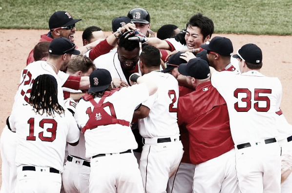 Boston mobs David Ortiz at second base following his game-winner. | Getty