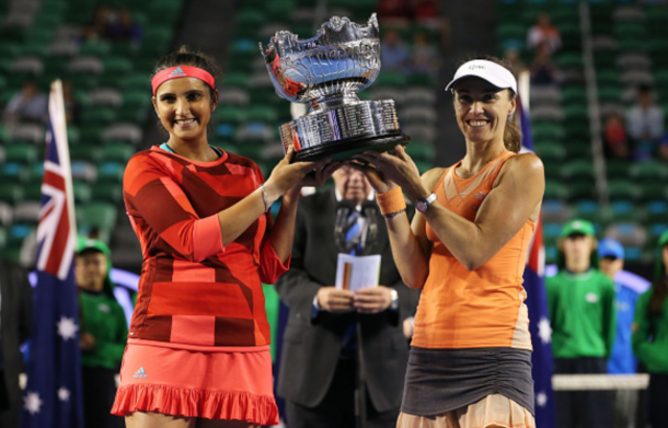 Martina Hingis of Switzerland and Sania Mirza of India pose with the championship trophy after winning their women's doubles final match against Andrea Hlavackova and Lucie Hradecka of the Czeck Republic during day 12 of the 2016 Australian Open at Melbourne Park on January 29, 2016 in Melbourne, Australia. (Photo by Scott Barbour/Getty Images)