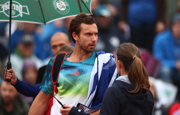 Ernests Gulbis of Latvia hits a backhand during the Men's Singles fourth round match against David Goffin of Belgium on day eleven of the 2016 French Open at Roland Garros on June 1, 2016 in Paris, France. (Photo by Julian Finney/Getty Images)