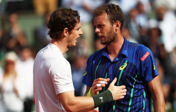 Andy Murray of Great Britain consoles the defeated Mathias Bourgue of France at the net following the Men's Singles second round match on day four of the 2016 French Open at Roland Garros on May 25, 2016 in Paris, France. (Photo by Julian Finney/Getty Images)