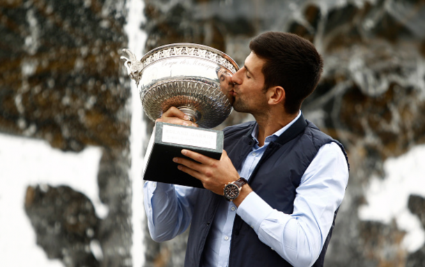Novak Djokovic of Serbia celebrates victory and poses for the photographers with the trophy a front the fontaine at the concorde near Champs Elysees in Paris, on June 6, 2016. (Photo by Mehdi Taamallah/NurPhoto via Getty Images)