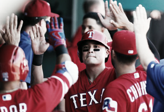 Shin-Soo Choo celebrates with teammates after crossing home plate in the seventh inning. | AP
