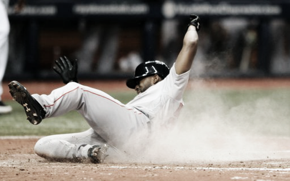 Jackie Bradley Jr. slides home on Travis Shaw's two-run double in the seventh inning. | AP