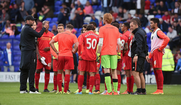 Klopp addresses his players on the pitch for his half-time team talk. (Picture: Getty Images)