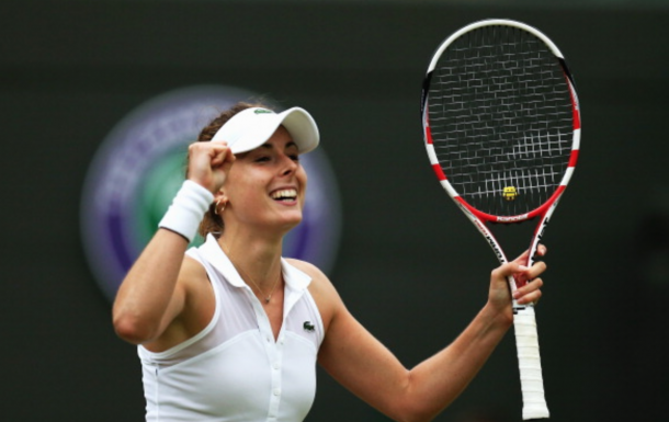 Alize Cornet of France celebrates after winning her Ladies' Singles third round match against Serena Williams of the United States on day six of the Wimbledon Lawn Tennis Championships at the All England Lawn Tennis and Croquet Club at Wimbledon on June 28, 2014 in London, England. (Photo by Steve Bardens/Getty Images)
