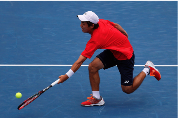 Nishioka gets low for the volley, keeping it short enough out of the reach of Dolgopolov. Credit: Kevin Cox/Getty Images
