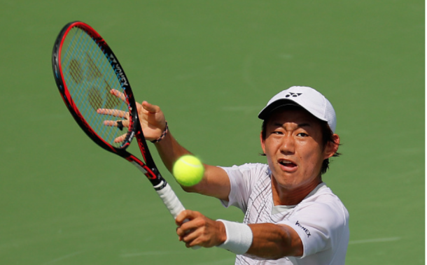 Just getting to the ball, Nishioka slices his shot back across the net. Credit: Kevin Cox/Getty Images
