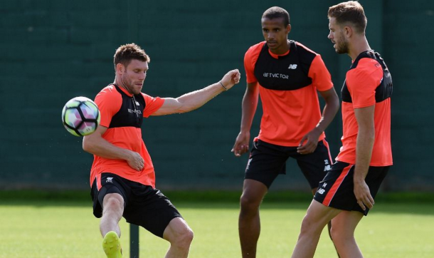 Milner with teammates Joel Matip and Jordan Henderson at Melwood. (Picture: Getty Images)