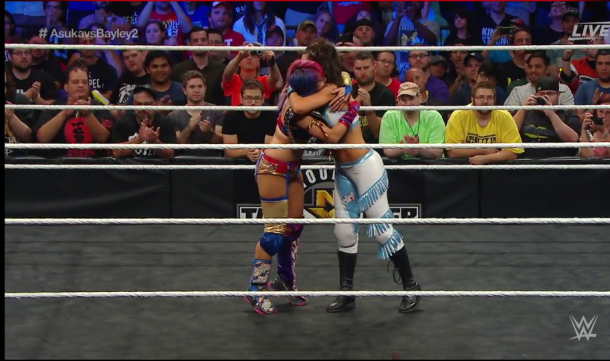 The two opponents hug in the middle of the ring (image: wwe network)