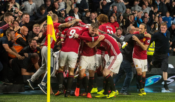 The United players celebrate the late goal with the away fans. (Picture: Ian Hodgson/Getty Images)