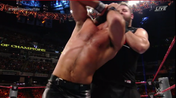 Kevin Owens keeps the punishment on Rollins (image: wwe network)