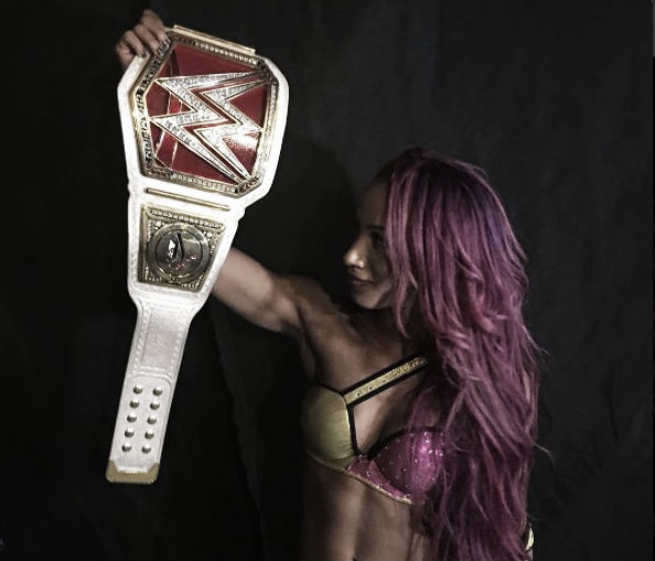 Sasha Banks proudly holds her women's title (image: twitter)