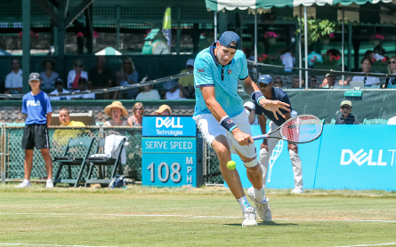 John Isner hits a slice return to Novikov