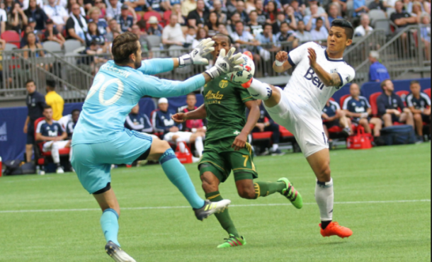 Fredy Montero (right) goes after a loose ball with Timbers goalkeeper Jake Gleeson | (Photo: John May - MLSGB) 