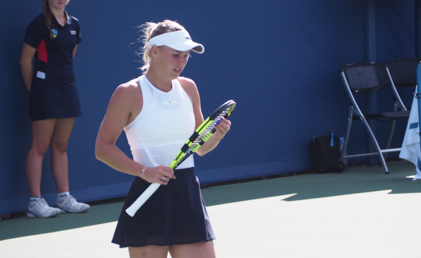 A frustrated Wozniacki looks at her racquet