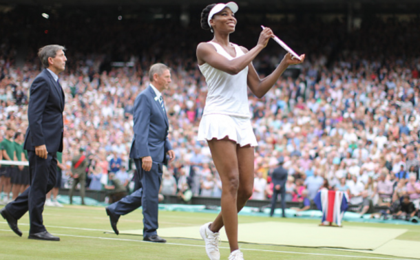 Venus Williams shows off her runner-up trophy after the Wimbledon final (Tim Clayton/Corbis/Getty Images)