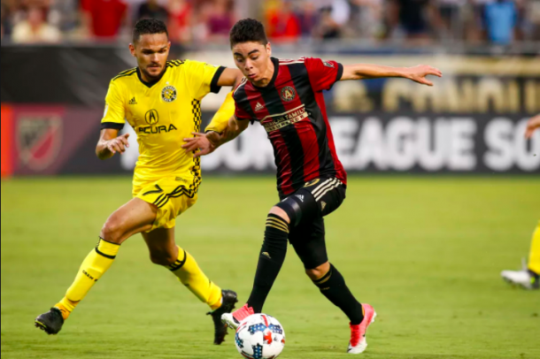 Artur (left) and Miguel Almiron (right) battle for possession. | Photo: Brett Davis - USA Today Sports