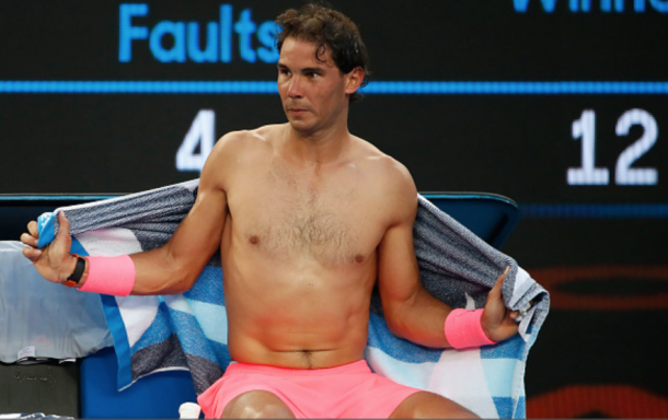 Nadal trying to cool himself off with a towel and changing his shirt (Scott Barbour/Getty Images)