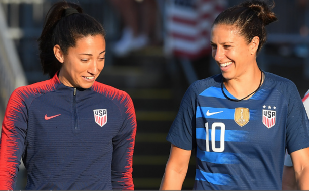 Christen Press (left) joins Carli Lloyd (right) in the 100 USWNT appearances club. (Photo by Rich Barnes/Getty Images)