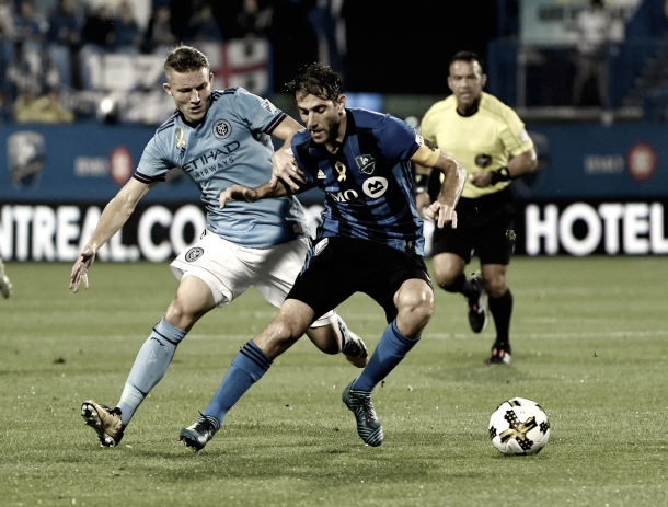 Alex Ring and Ignacio Piatti fighting for possession. | Photo: NYCFC