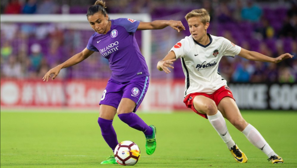 Marta (left) shields the ball from Rebecca Quinn. | Photo: isiphotos.com