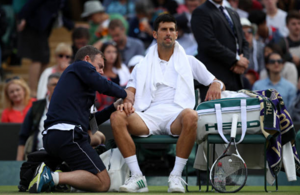 Novak Djokovic getting treated for his elbow (Photo: Julian Finney/Getty Images)