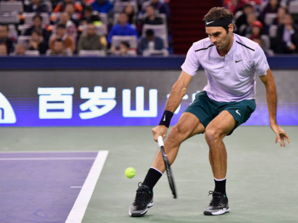 Roger Federer reaches down low for a return shot (Photo: Lintao Zhang/Getty Images)