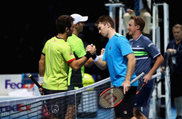 Jean-Julien Rojer and Horia Tecau shake and congratulate Henri Kontinen and John Peers on their win (Photo: Clive Brunskill/Getty Images)