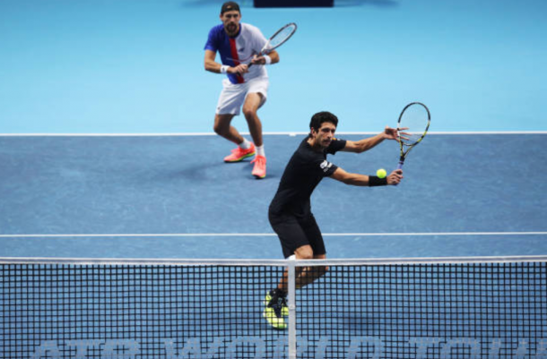 Marcelo Melo puts away a volley with Lukasz Kubot watching on (Photo: Julian Finney/Getty Images)