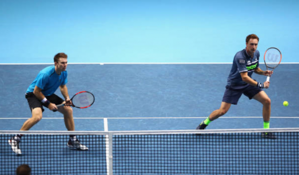 Henri Kontinen strikes a return shot with John Peers ready to react (Photo: Clive Brunskill/Getty Images)