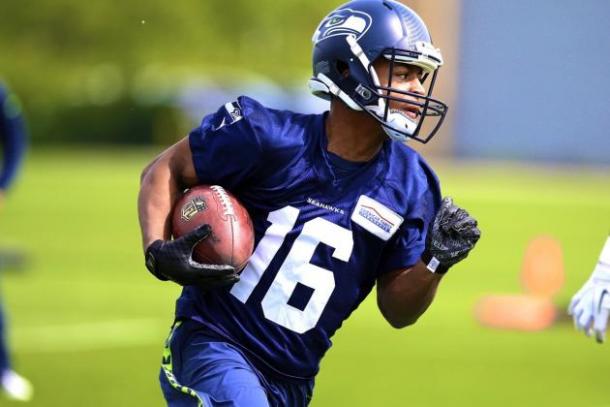 Seattle Seahawks wide receiver Tyler Lockett carries the ball during practice at the team's training facility. Image via AP Images