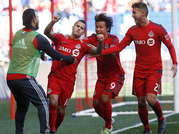 Sebastian Giovinco (red, #10) celebrating with teammates after scoring a goal. Photo credit: Jeff Zelevansky/Getty Images Sport 