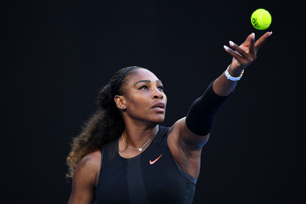 Serena Williams tosses a ball in preparation to hit a serve against Venus Williams during the final of the 2017 Australian Open. | Photo: Quinn Rooney/Getty Images