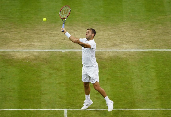 Daniel Evans smashes a forehand volley, taking the point. Credit: Shaun Botterill/Getty Images