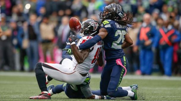 Richard Shermand (right) breaks up a pass intended for Julio Jones late in the 4th quarter | Source: Otto Greile, Jr. - Getty Images