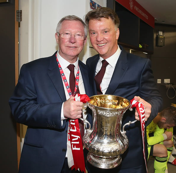 Louis van Gaal holds the FA Cup with former-manager Sir Alex Ferguson | Photo: Matthew Peters/Manchester United