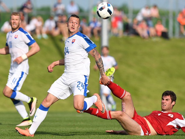 Solomon Kakabadze of Georgia (R) and Slovakia's Adam Zrelak vie for a ball  Photo: JOE KLAMAR/AFP/Getty Images